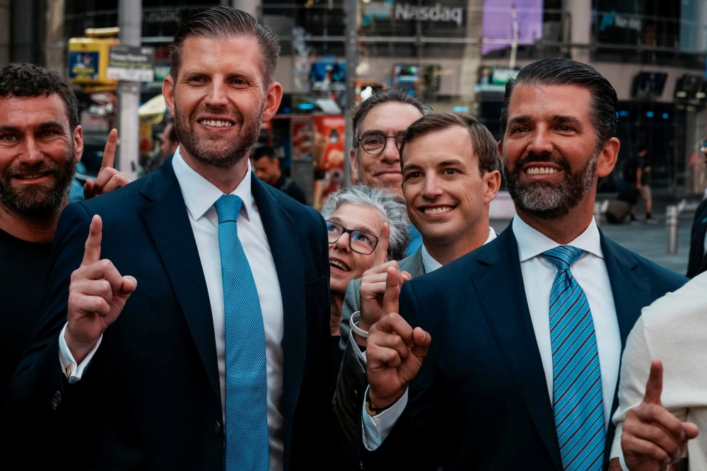 Donald Trump Jr., Eric Trump and World Liberty Financial co-founder Zach Witkoff gesture outside the Nasdaq building after ringing the opening bell in New York City on August 13, 2025. — Reuters pic