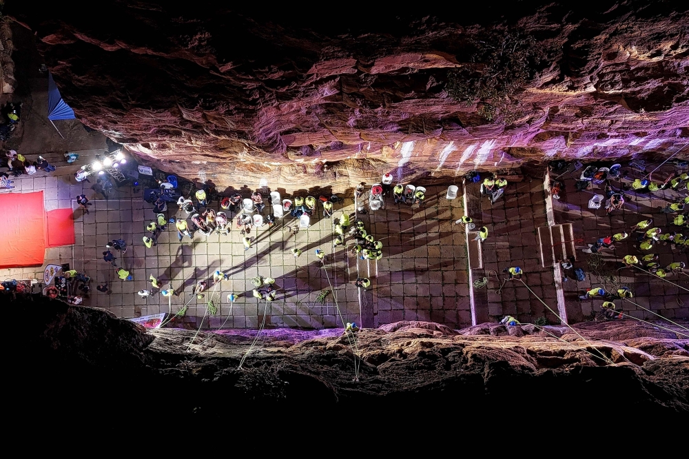 This aerial photograph taken on March 28, 2026 shows climbers scaling a rock wall during a rock-climbing festival at a sandstone cliffs site in Karnataka’s Badami town. — AFP pic