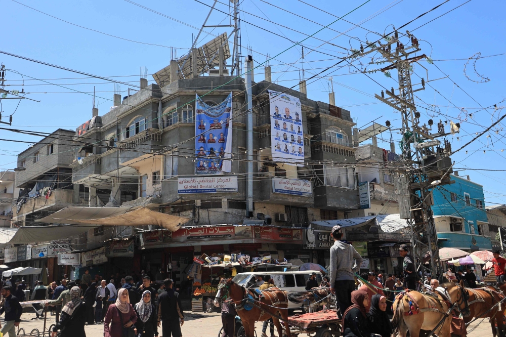 Election campaign banners showing candidates for the upcoming municipal elections hang on a building in Deir el-Balah in the central Gaza Strip on April 21, 2026. — AFP pic 