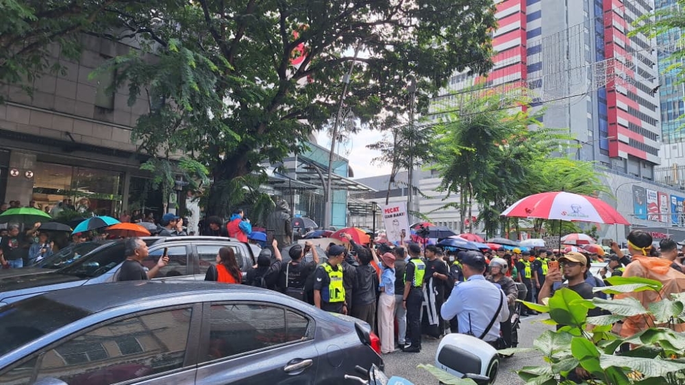 Attendees gather to watch speakers deliver speeches during a rally against Tan Sri Azam Baki, in Kuala Lumpur on April 25, 2026. — Picture by Ida Lim