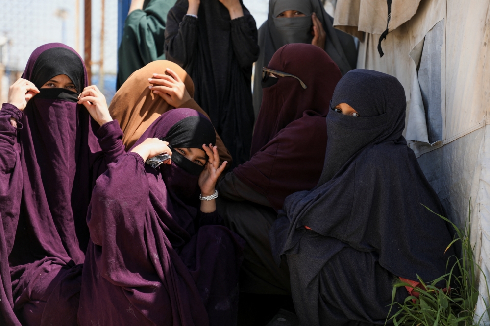 Members of Australian families believed to be linked to the Islamic State militants wait to leave Roj camp near Derik, Syria April 24, 2026. — Reuters pic  