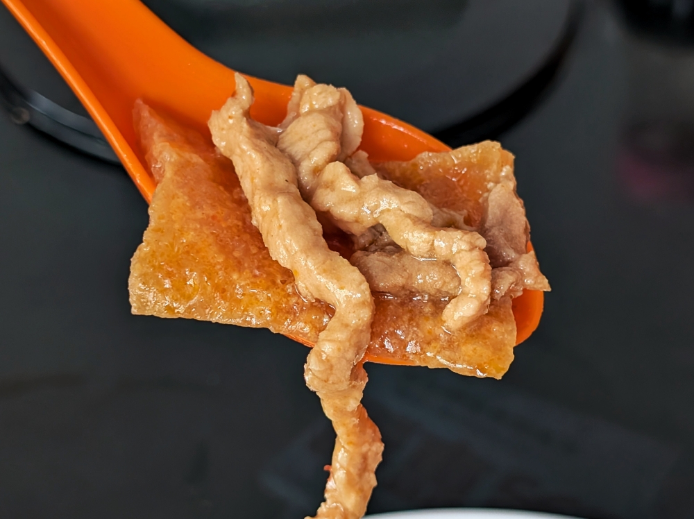 Lean pork strips in the mushroom sauce make for a good contrast against the spongy pork rind of the curry. — Picture by Ethan Lau