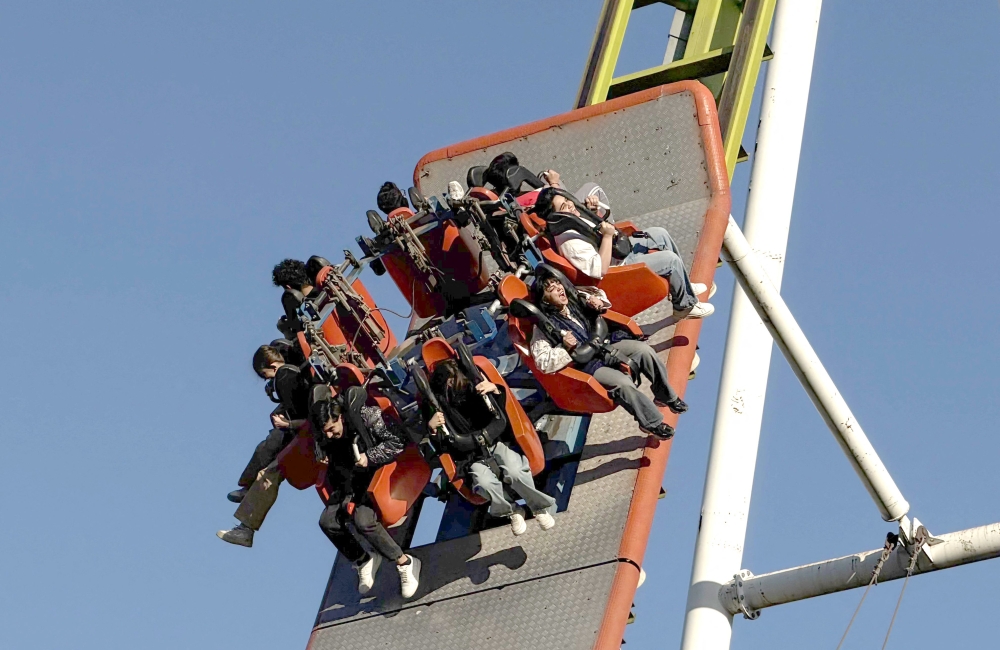 Iranians enjoy an amusement ride at Game City at Chitgar Lake, an artificial recreational lake and park officially known as the Lake of the Martyrs of the Persian Gulf, in northwestern Tehran on April 26, 2026. — AFP pic