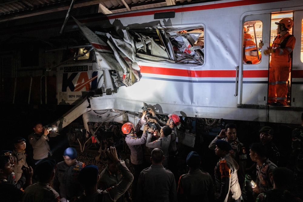 Rescuers work at the site where a passenger train locomotive pierced through the rear carriage of a commuter train at Bekasi Timur Station in Bekasi on April 28, 2026. — AFP pic