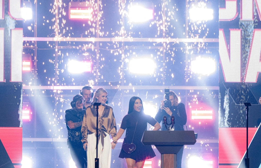 Turning Point USA CEO and chair Erika Kirk and US rapper Nicki Minaj arrive on stage during the AmericaFest conference in Phoenix on December 21, 2025. — AFP pic