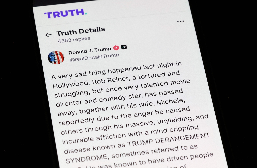 In this photo illustration, a phone shows US President Donald Trump’s Truth Social post on the death of actor and director Rob Reiner in Washington on December 15, 2025. — AFP pic