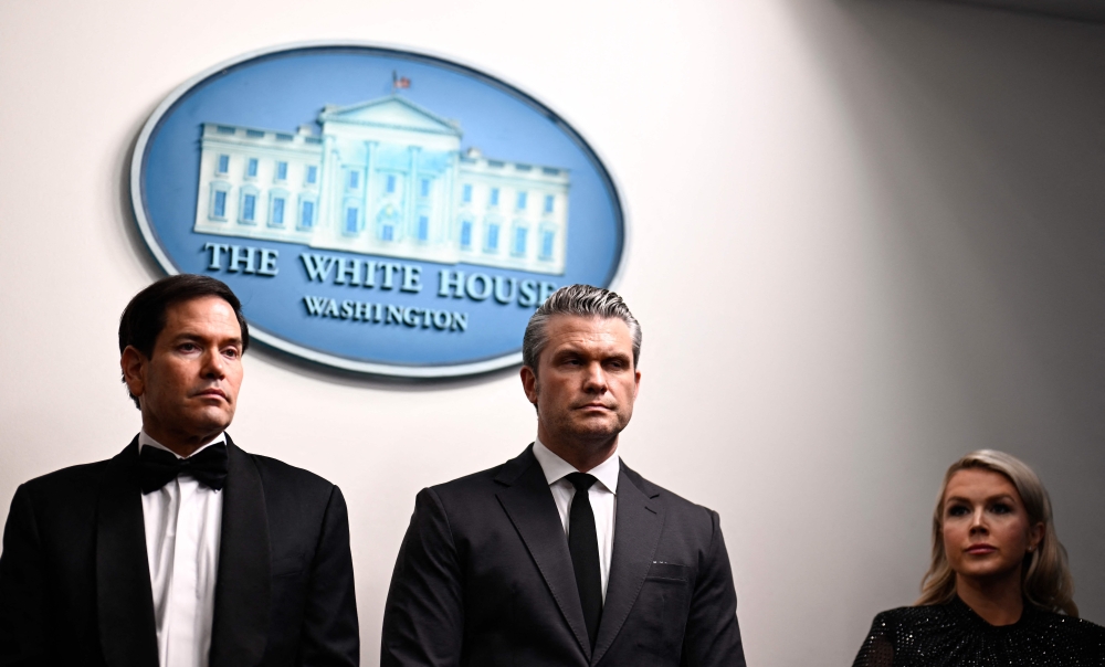US Secretary of State Marco Rubio, US Defense Secretary Pete Hegseth and White House Press Secretary Karoline Leavitt listen as US President Donald Trump speaks during a press briefing in the Brady Briefing Room at the White House in Washington on April 25, 2026. — AFP pic