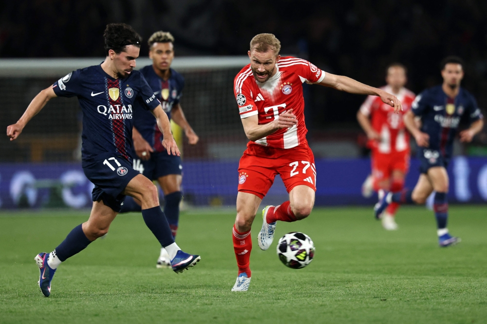 Paris Saint-Germain midfielder Vitinha fights for the ball with Bayern Munich midfielder Konrad Laimer during the UEFA Champions League semi-final first leg match at the Parc des Princes in Paris on April 28, 2026. — AFP pic