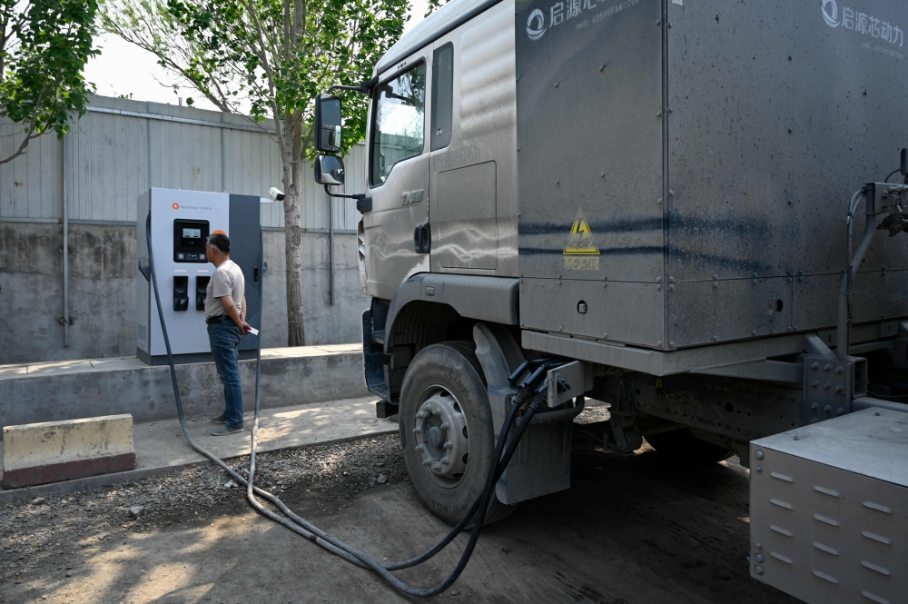 Electric trucks in China surge as lower costs and charging network disrupt logistics