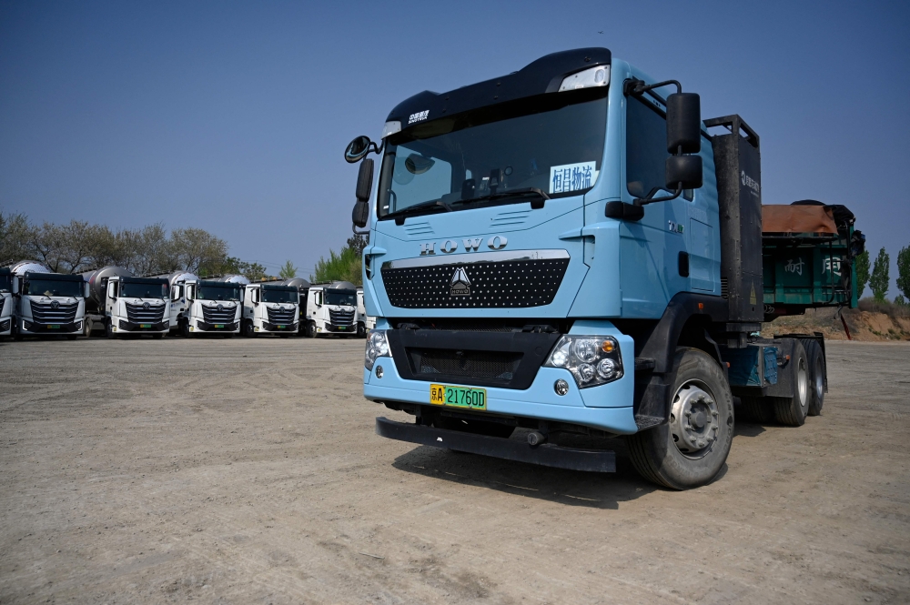At a dusty lot an hour outside Beijing, a steady stream of vehicles come and go for a quick battery charge — just one node in China’s rapidly expanding network of electric trucks. — AFP pic 
