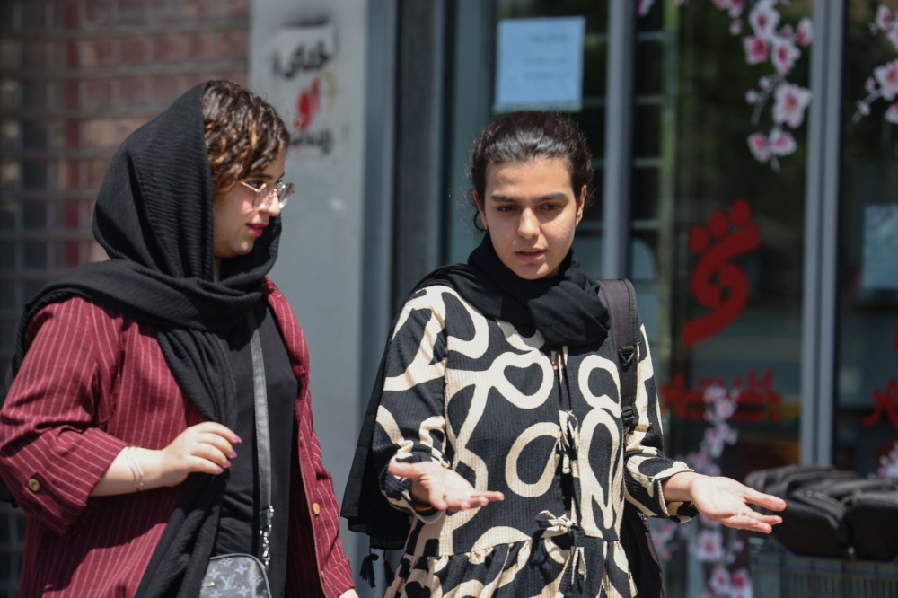Iranian women walk at the Revolution Square in Tehran on April 28, 2026. — AFP pic   