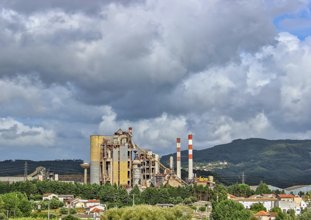 A cement plant operates alongside nearby residential areas, highlighting the growing debate over whether the industry’s shift toward circular economy practices is delivering environmental gains while also ensuring social justice for surrounding communities. — Unsplash pic