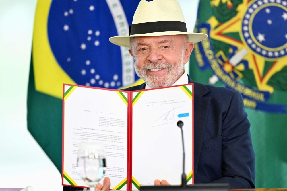 Brazil's President Luiz Inacio Lula da Silva shows the signed decree enacting the Trade Agreement between the European Union and Mercosur at the Planalto Palace in Brasilia April 28, 2026. — AFP pic 