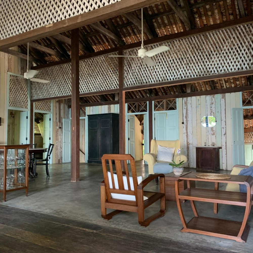Built from reclaimed timber and designed for natural ventilation, the house reflects a balance between old-world architecture and modern sustainability.