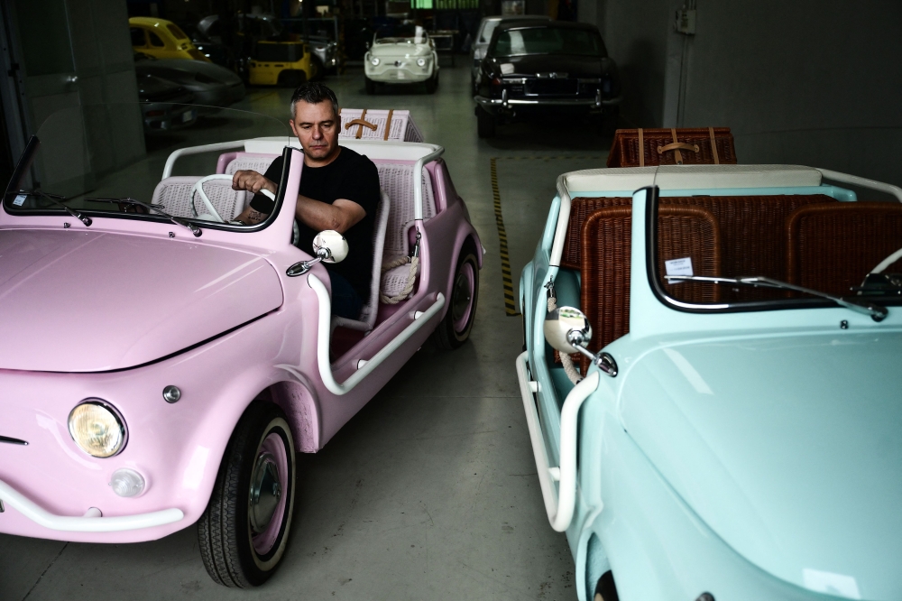 Owner of the Officine Gentile garage, Giovanni Gentile sits at the wheel of a model of a Fiat 500 Jolly Lido at his workshop in Turin on April 30, 2026. — AFP pic