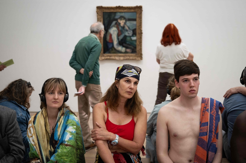 Visitors wearing swimsuits look at a painting during the experience called “bathers’ day” (“journée des baigneurs et des baigneuses”) inspired by Italian artist Maurizio Cattelan, on the occasion of the exhibition “Cezanne” of the French painter Paul Cezanne at the Beyeler Foundation in Riehen, northern Switzerland on May 1, 2026. — AFP pic