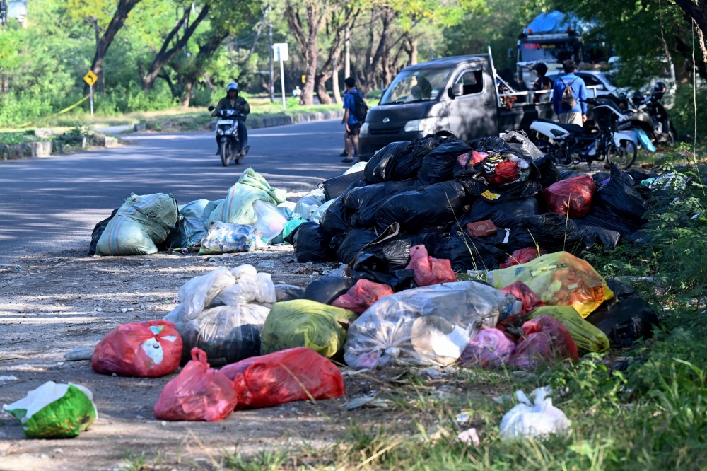 Rubbish piles up on a street in Denpasar on Indonesia’s resort island of Bali on April 24, 2026. — AFP pic