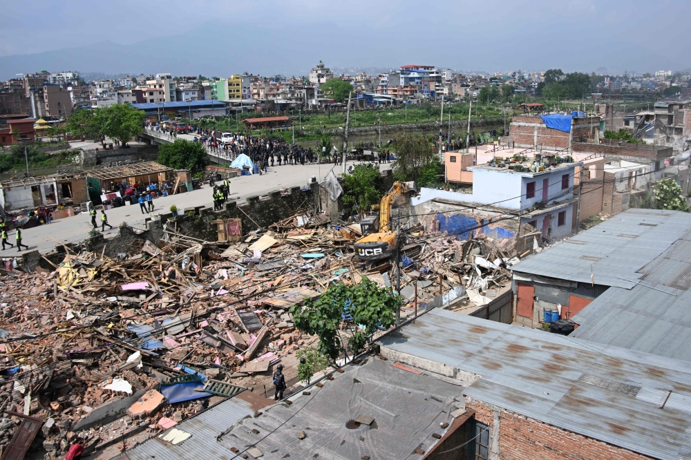 Heavy construction equipment is used to demolish squatter settlements near the Bagmati River in Kathmandu on May 1, 2026. — AFP pic