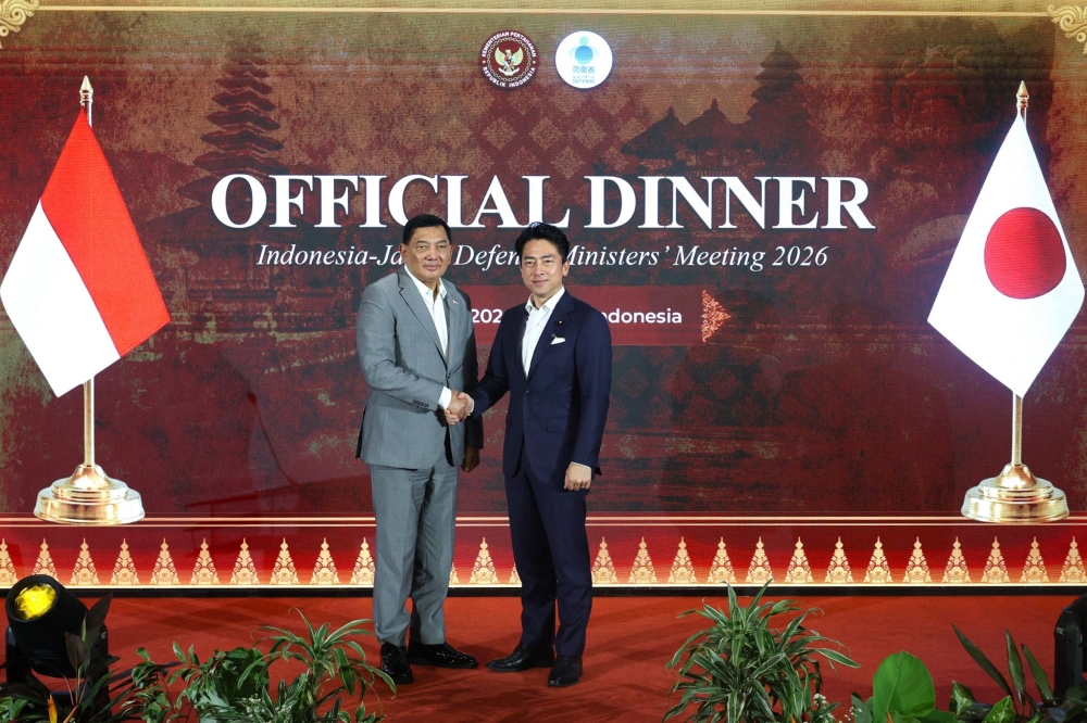 Indonesia’s Defence Minister Sjafrie Sjamsoeddin (left) shakes hands with Japan’s Defence Minister Shinjiro Koizumi during an official dinner in Bali. — Handout photo by Indonesia's Ministry of Defence/AFP