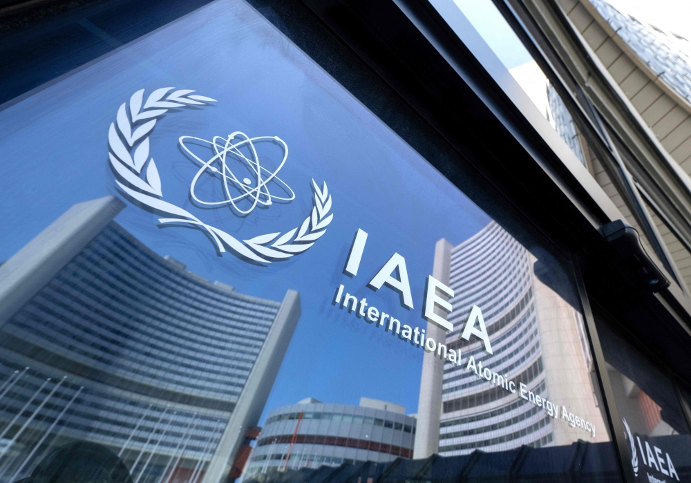 Buildings of the International Atomic Energy Agency headquarters reflect in doors with the agency’s logo in Vienna, Austria on June 13, 2025. — AFP pic