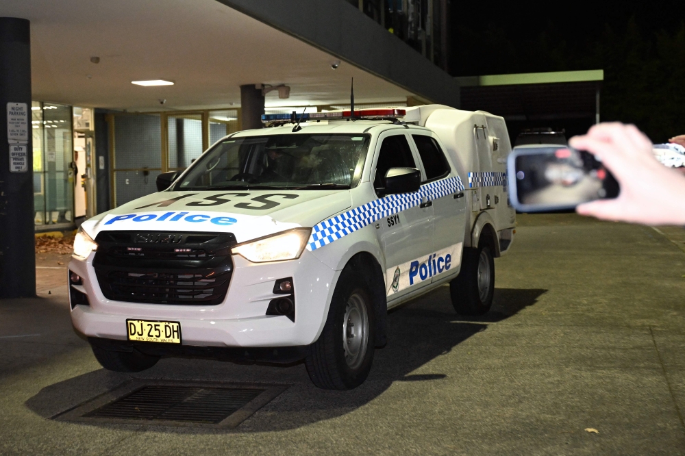 A police van carries away one of the Australian women linked to alleged Islamic State jihadists from Mascot Police Station in Sydney on May 7, 2026, following her arrest on arrival at Sydney airport and subsequent interrogation. — AFP pic 