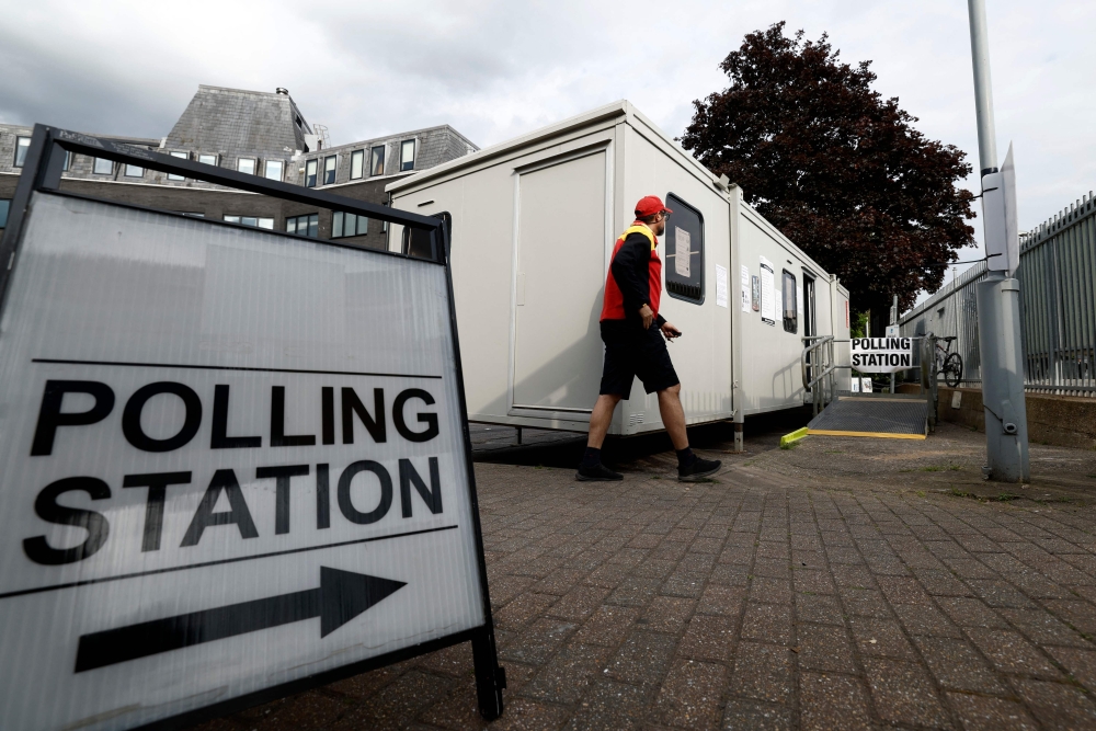 A person departs a temporary polling station set up in a Portakabin in Norbiton, southwest London on May 7, 2026. Polls opened at 7:00 am (0600 GMT) on May 7 across Scotland, England and Wales in the local ballots that are Britain's Prime Minister Keir Starmer's biggest electoral test since his July 2024 general election landslide victory ended 14 years of Conservative rule. — AFP pic 