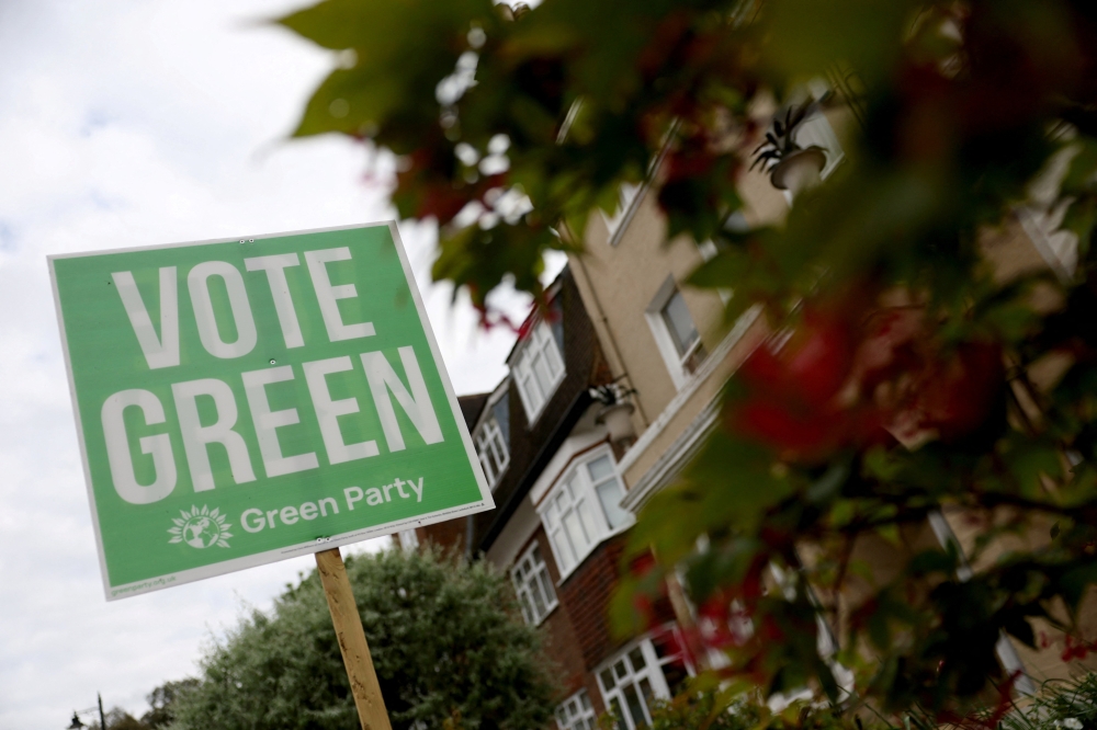 A sign supporting the Green Party political party is displayed in a residential street on the eve of local and mayoral elections in England and devolved parliamentary elections in Wales and Scotland on May 7, in London May 6, 2026. — AFP pic