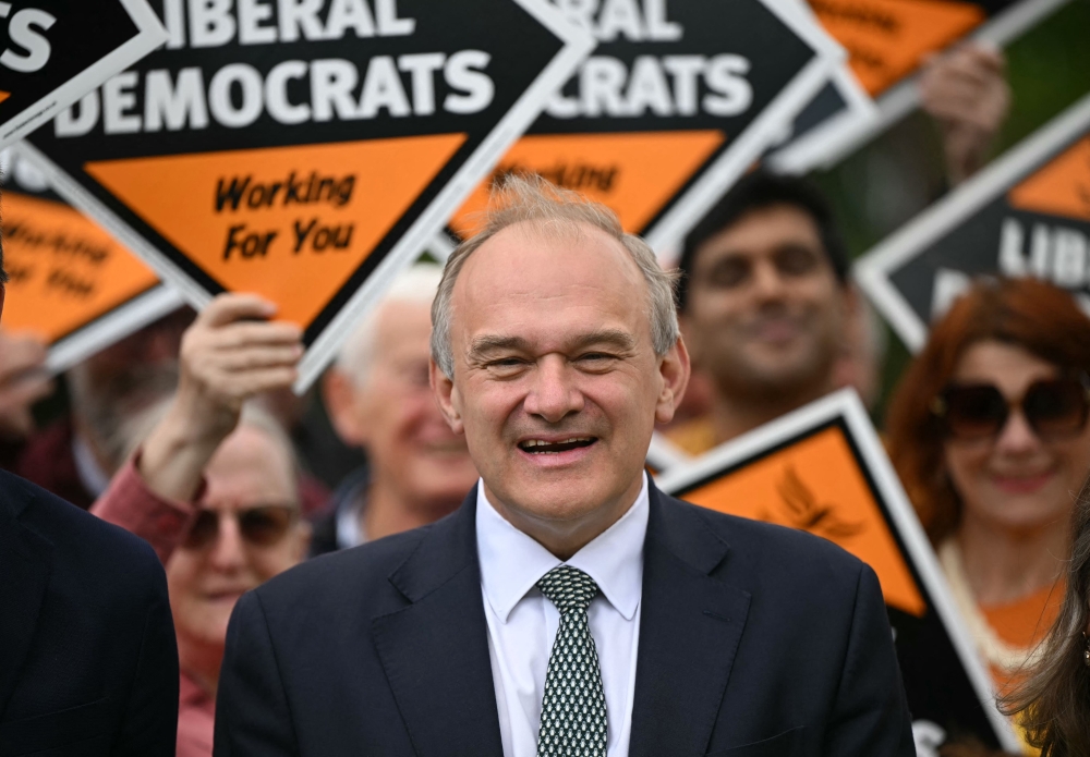 Britain’s Liberal Democrat party leader Ed Davey poses for a photo with supporters speaks during a local election tour in Redhill, Surrey, south of London on May 6, 2026, a day before British local elections. — AFP pic