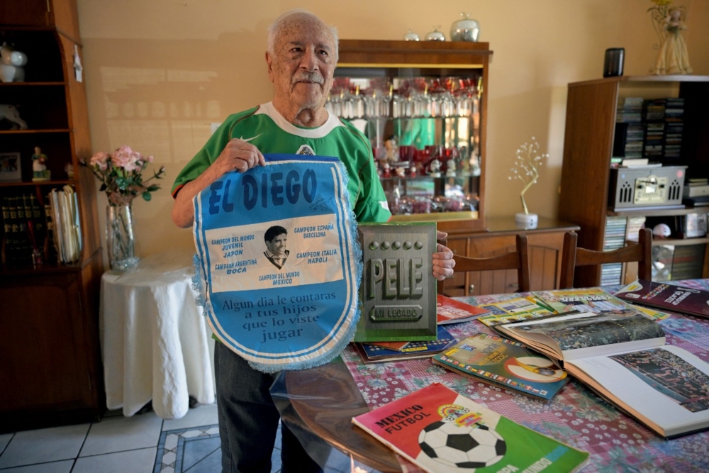Mexican retired employee and football fan Fernando Rueda, 86, shows mementos from previous World Cups during an interview with AFP in Mexico City on March 21, 2026. The Ruedas, Fernando, Jairo and Emilio, are three generations of Mexicans who can no longer afford a World Cup ticket due to the surge in prices compared with the two previous tournaments hosted in the country. — AFP pic 