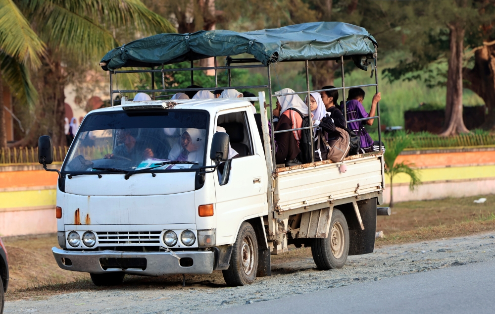 Some students at SMK Banggi use lorries as their main means of transport to get to school. — Bernama pic