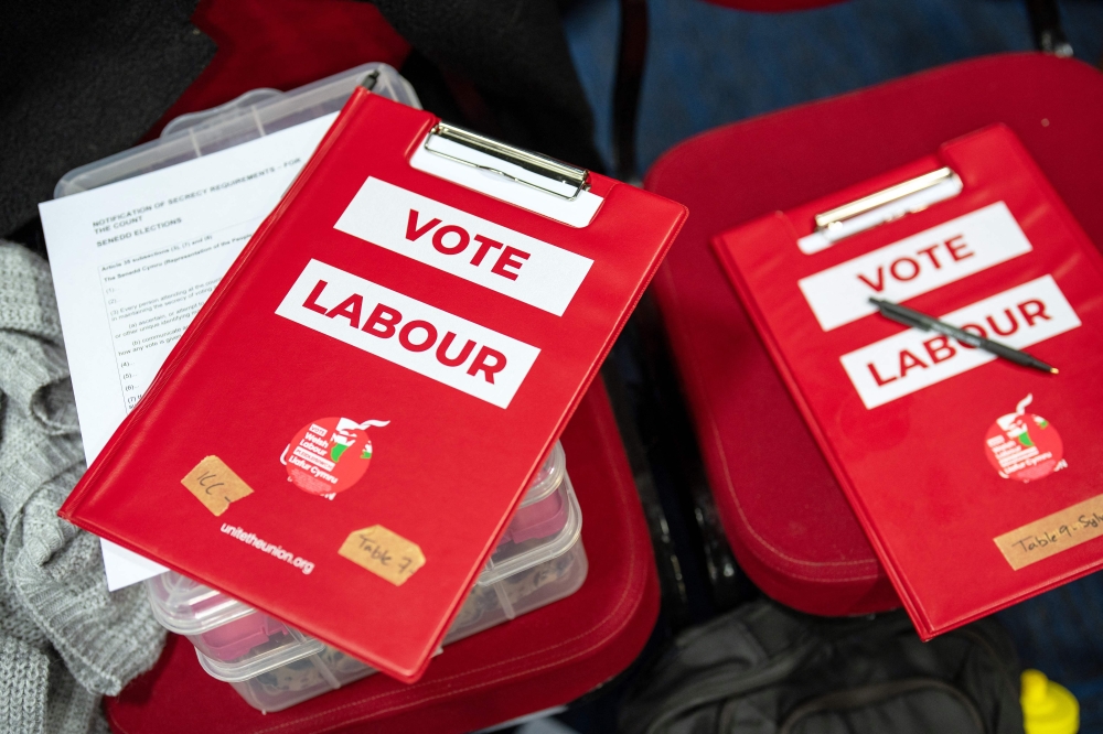 Clipboards belonging to Labour party members are pictured as staff count votes on ballot papers the morning after local elections at a vote-counting centre in Llandudno, north Wales May 8, 2026. — AFP pic