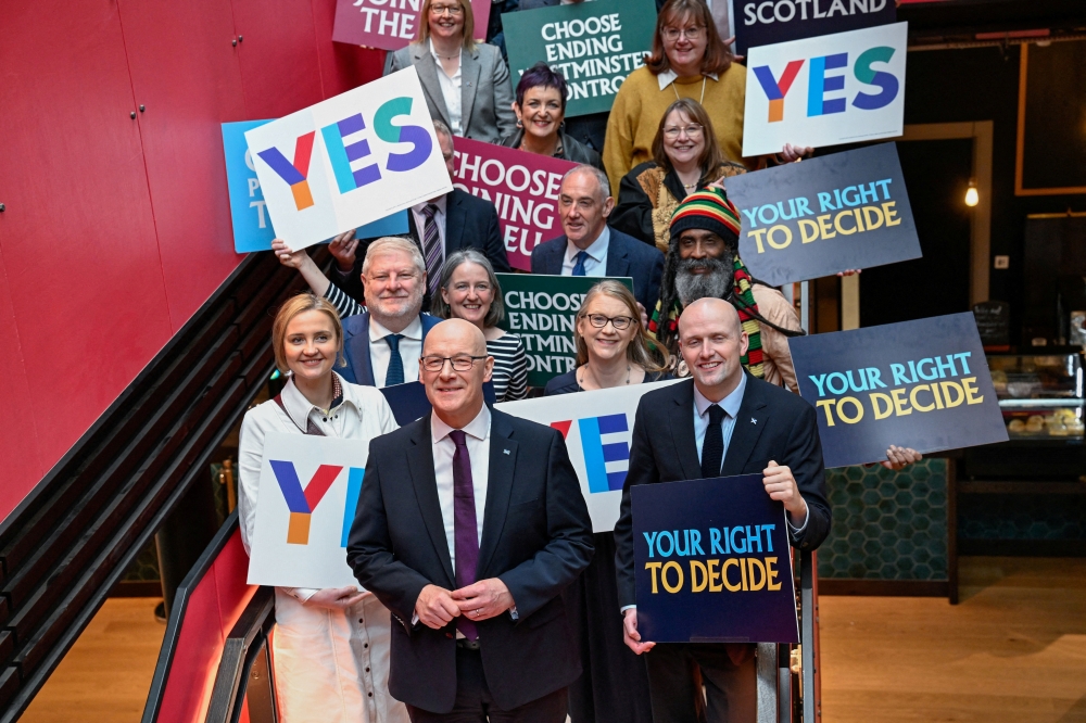 Scottish First Minister and SNP leader John Swinney poses with candidates after giving a speech at the launch of the party's campaign ahead of the 2026 Scottish Parliament election due to be held on May 7, in Glasgow, Scotland March 26, 2026. — Reuters pic