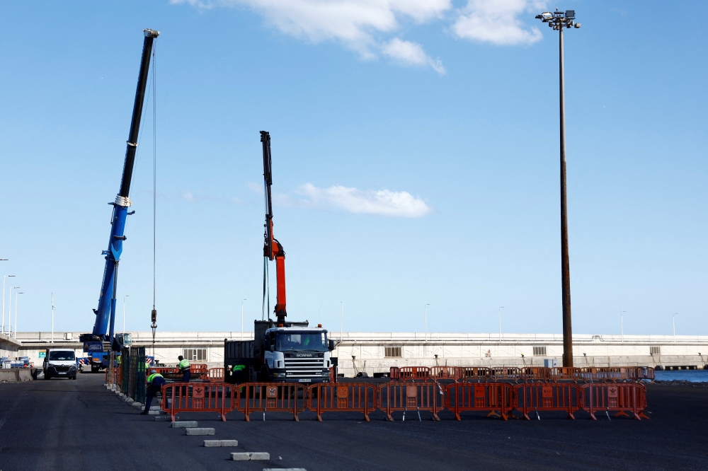 Workers prepare security measures at the port of Granadilla de Abona, Tenerife, Canary Islands, Spain, where the cruise ship MV Hondius affected by a deadly hantavirus outbreak is expected to arrive, May 8, 2026. — Reuters pic