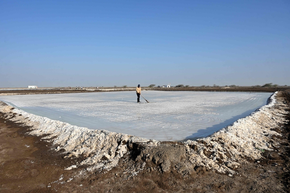 A worker harvests salt at the Little Rann of Kutch (LRK) region of Gujarat on April 29, 2026. India faces challenging heatwaves each year, but few places endure conditions as searing as the country's western desert salt pans, where workers rely on simple techniques to survive almost unbearable temperatures. In Gujarat's Little Rann of Kutch summer temperatures routinely cross 45 degrees Celsius  and can climb to 47–48C. Up to 50,000 workers spend eight months on the remote salt pans without electricity or healthcare, relying on a tanker to deliver drinking and washing water every 25 days. — AFP pic