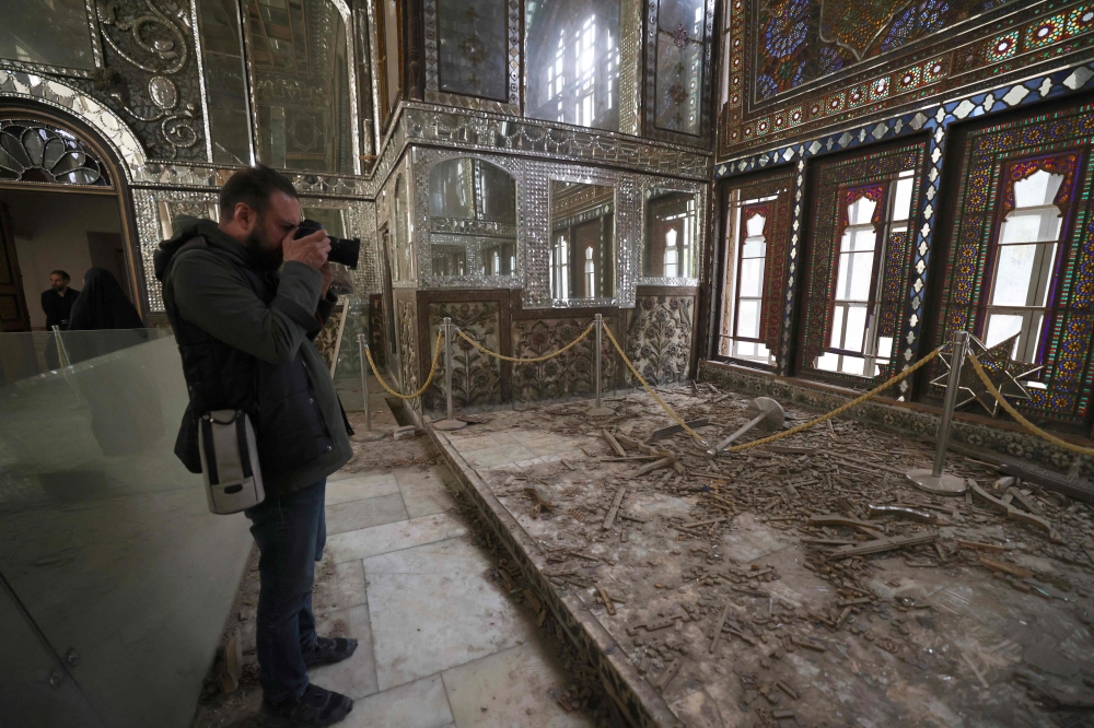 A photographer takes pictures of the damaged interiors of the historic Golestan Palace in Tehran on April 4, 2026. Since the start of the war, a senior Tehran cultural official said US and Israeli strikes have damaged at least 120 museums and cultural and historic sites nationwide, including the capital's UNESCO-listed Golestan Palace -- sometimes likened to Versailles. The palace complex is one of the oldest sites in the Iranian capital and once served as the residence of the Qajar dynasty. — AFP pic
