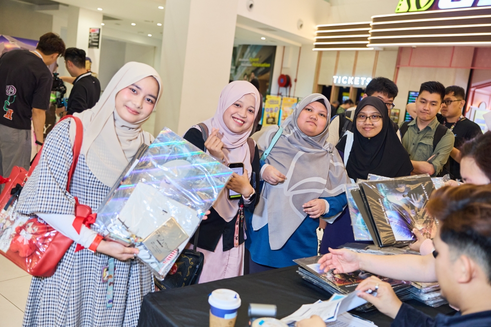 Fans showcase their Gundam merchandise during Saturday’s gala premiere of ‘Mobile Suit Gundam Hathaway: The Sorcery of Nymph Circe’. — Picture courtesy of GSC Cinemas