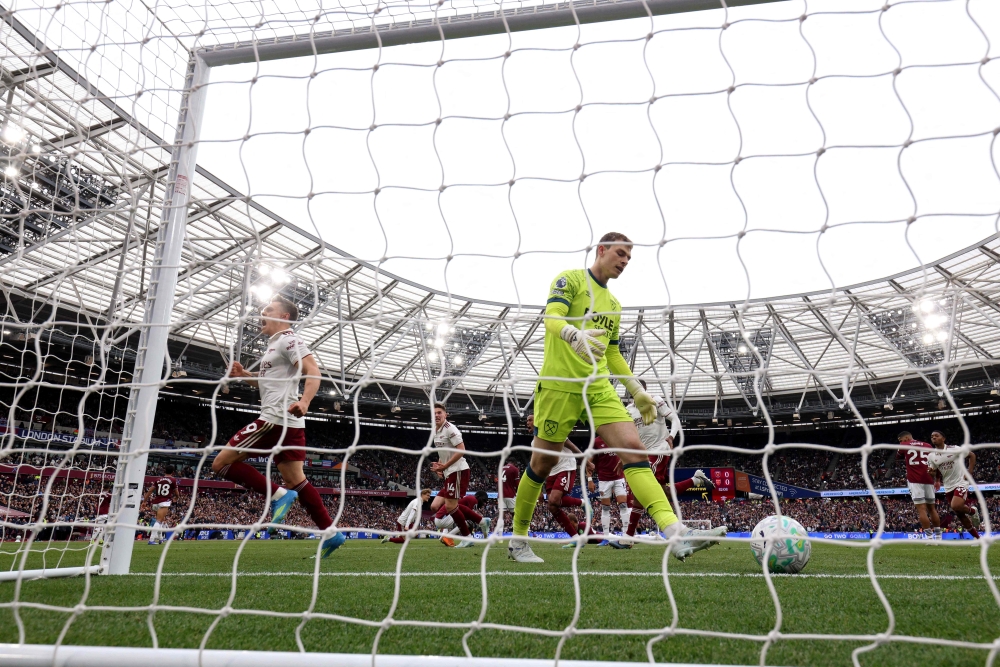 Arsenal’s Belgian midfielder #19 Leandro Trossard celebrates scoring the team’s first goal past West Ham United’s Danish goalkeeper #01 Mads Hermansen during the English Premier League football match between West Ham United and Arsenal at the London Stadium May 10, 2026. — AFP pic