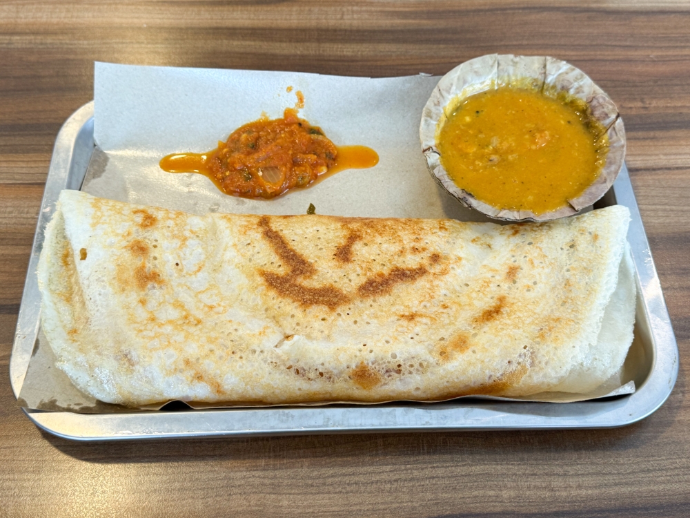 Ghee Thosai looks pale but it's crispy and good paired with a chunky tomato chutney and dhal — Picture by Lee Khang Yi
