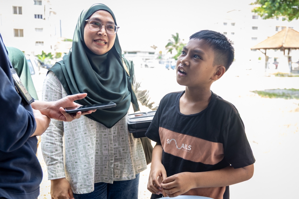 Muhammad Qalish Mikhail Masri and his mother, Linda Mat Desa, speaking to Malay Mail.