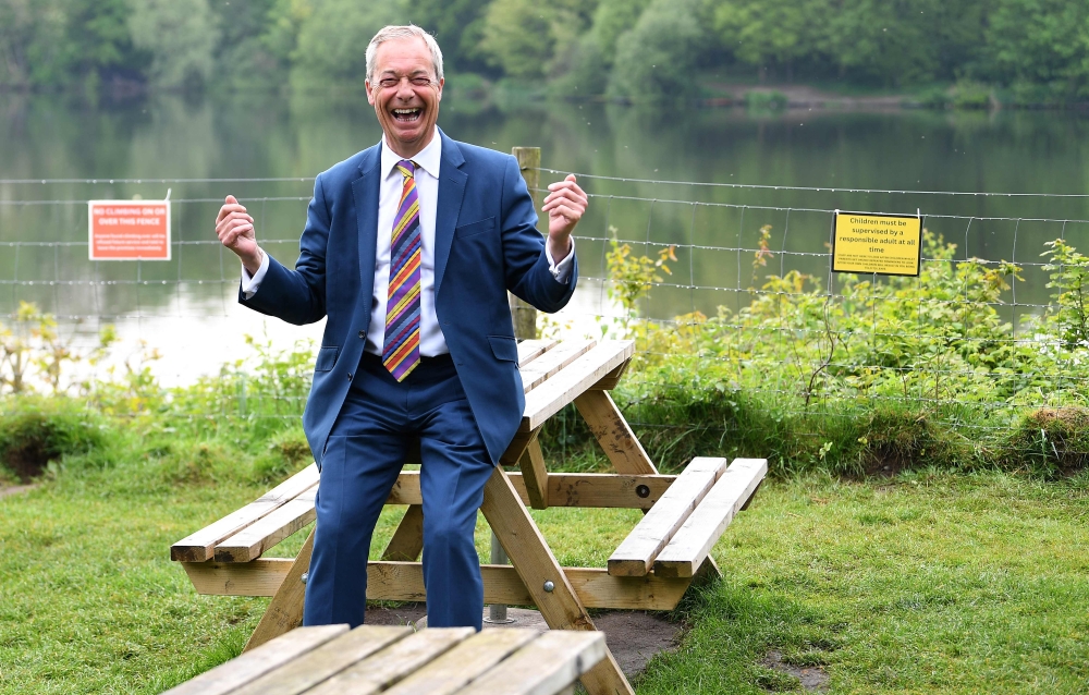 Reform UK leader Nigel Farage reacts during a visit to St Helens, north west England on May 8, 2026. — AFP pic