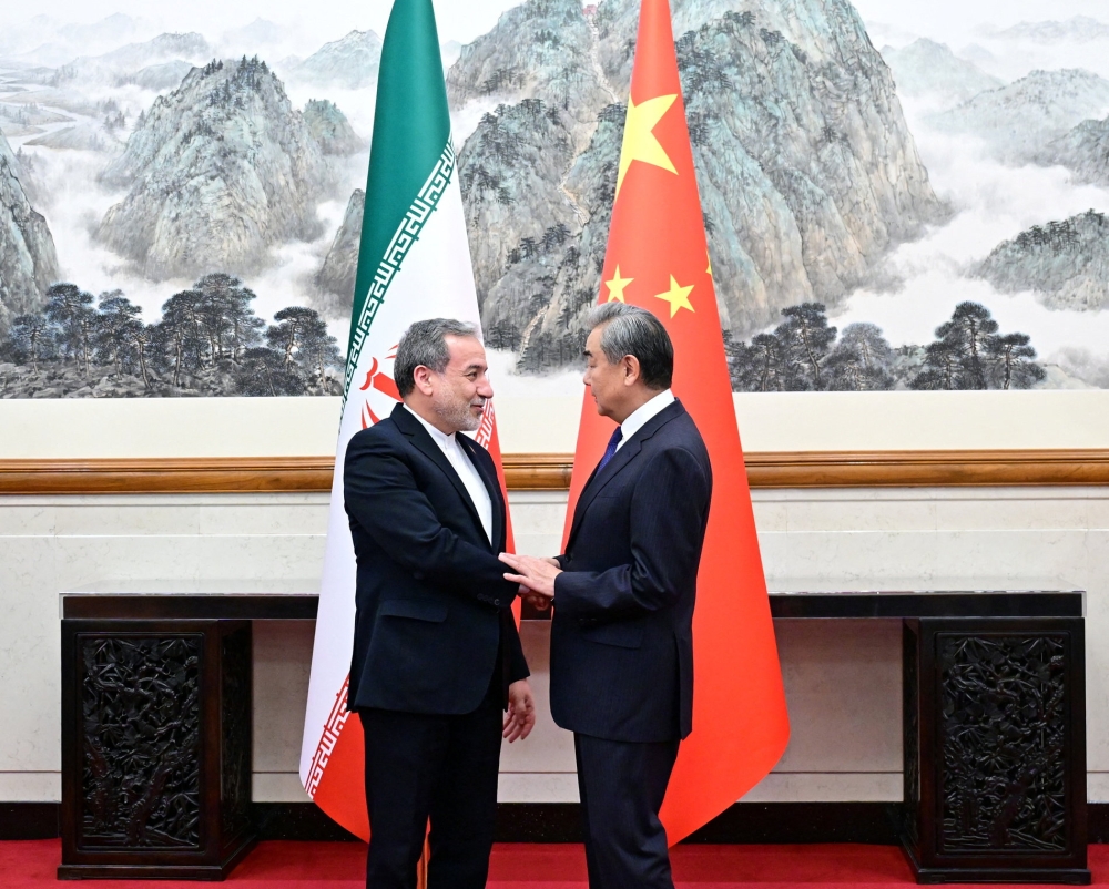 Chinese Foreign Minister Wang Yi and Iranian Foreign Minister Abbas Araqchi shake hands in Beijing, China on May 6, 2026. — Reuters pic