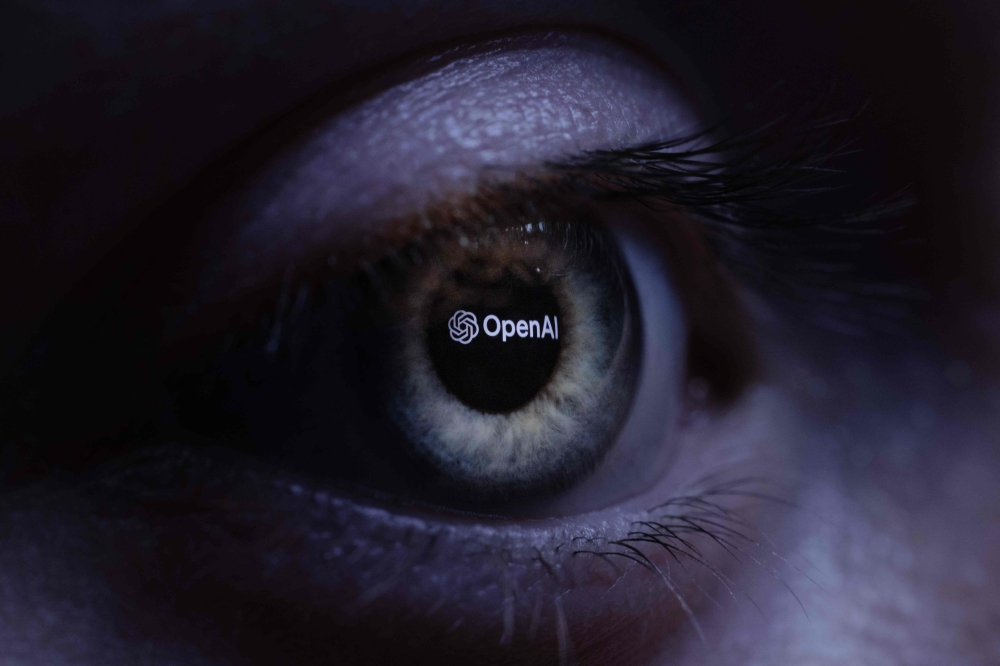 An “OpenAI” logo is seen reverse projected onto a human eye in Paris on June 6, 2023. — AFP pic