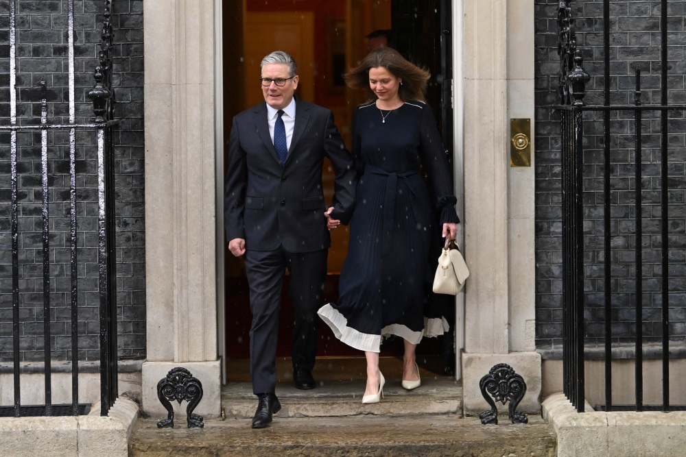 British Prime Minister Keir Starmer and his wife Victoria Starmer walk on Downing Street, on the day of the State Opening of Parliament, in London May 13, 2026. Any candidate wishing to make ⁠a challenge would need to secure the support of 20 per cent ⁠of Labour members of parliament. — Reuters pic