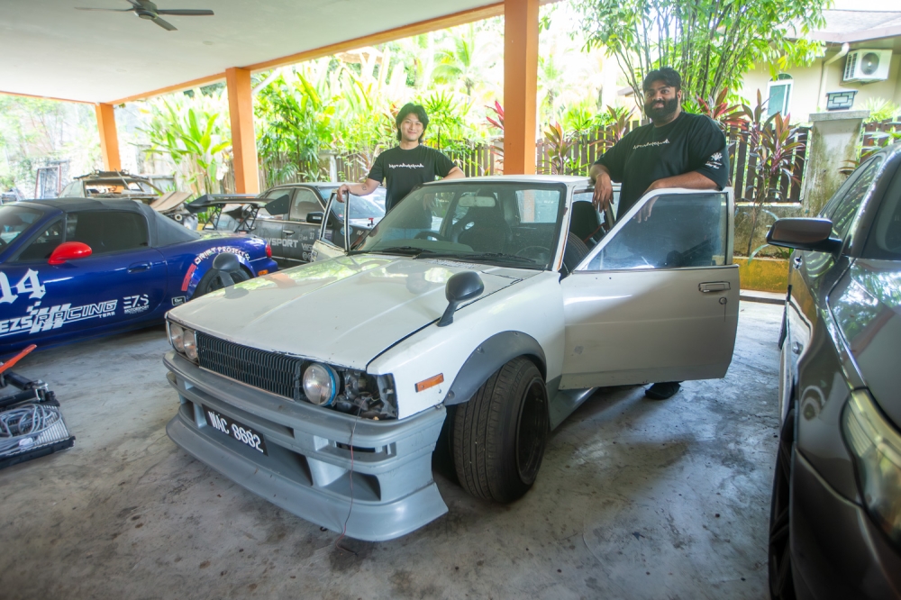 Chen and Beysshwen posing with their modified Corolla KE70, the car that kickstarted their drifting journey back in 2019. — Picture by Raymond Manuel