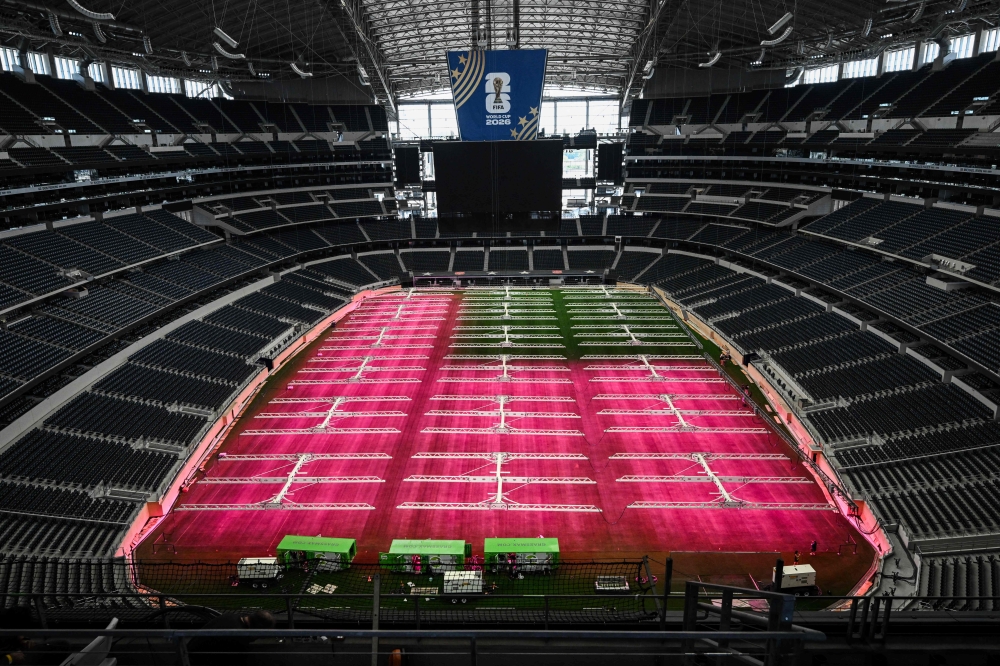 Dallas Stadium (temporarily renamed from AT&T Stadium for the 2026 FIFA World Cup) is seen with purple lights illuminating the field to promote grass growth, in Arlington, Texas, on May 14, 2026. — AFP pic
