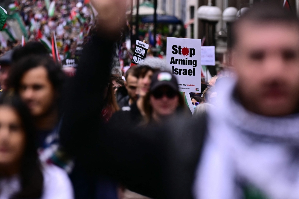 Protesters holding Palestinian flags and placards march along Piccadilly in central London during a ‘Nakba’ demonstration in support of Palestine and against the Far Right, organised by Stop The War coalition on May 16, 2026. — AFP pic
