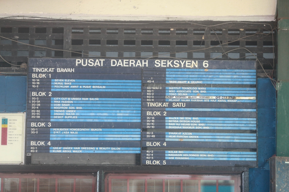 An outdated signboard at Pusat Daerah Seksyen 6 with a list of tenants. — Picture by Sayuti Zainudin