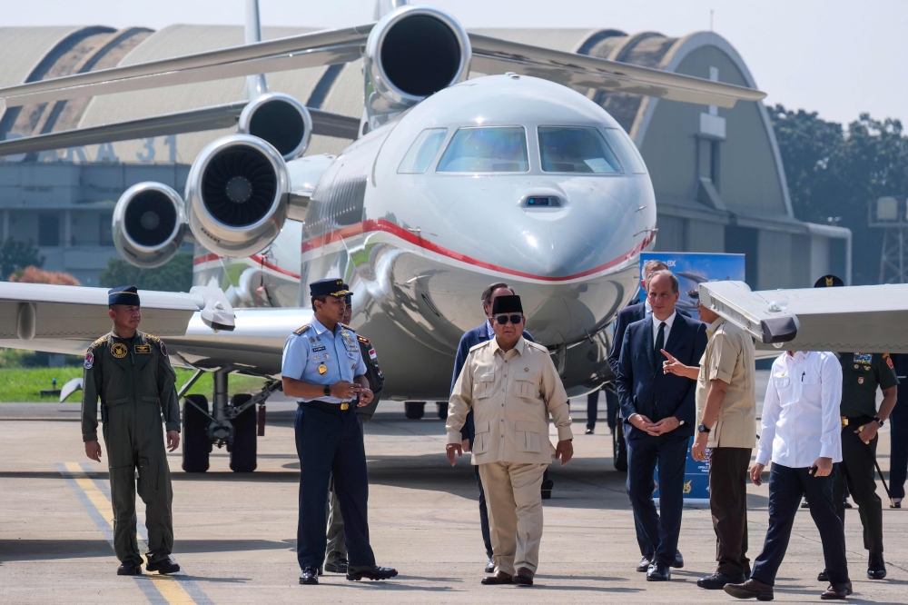 Indonesian President Prabowo Subianto (centre) walks with high-ranking officials while inspecting six new Rafale jet fighters, six Dassault Falcon 8X aircrafts and two Airbus A400M Atlas transport planes being handed over to the Indonesian Air Force during a ceremony at Halim Perdanakusuma Air Force Base in Jakarta on May 18, 2026. — AFP pic