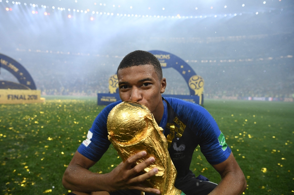 This file picture shows France forward Kylian Mbappe kissing the Fifa World Cup trophy after France defeated Croatia in the 2018 final at the Luzhniki Stadium in Moscow, July 15, 2018. — AFP pic This file picture shows France forward Kylian Mbappe kissing the Fifa World Cup trophy after France defeated Croatia in the 2018 final at the Luzhniki Stadium in Moscow, July 15, 2018. — AFP pic