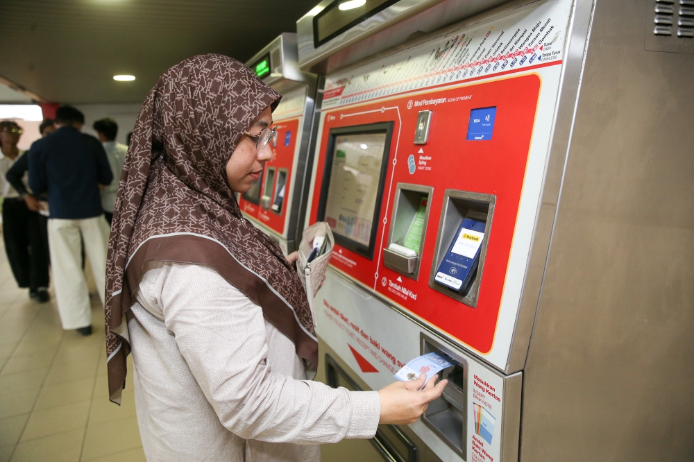 You can use cash, credit card or debit card at the ticket machine to buy a token or top-up your Touch ‘n Go card for a train ride. — Picture by Choo Choy May